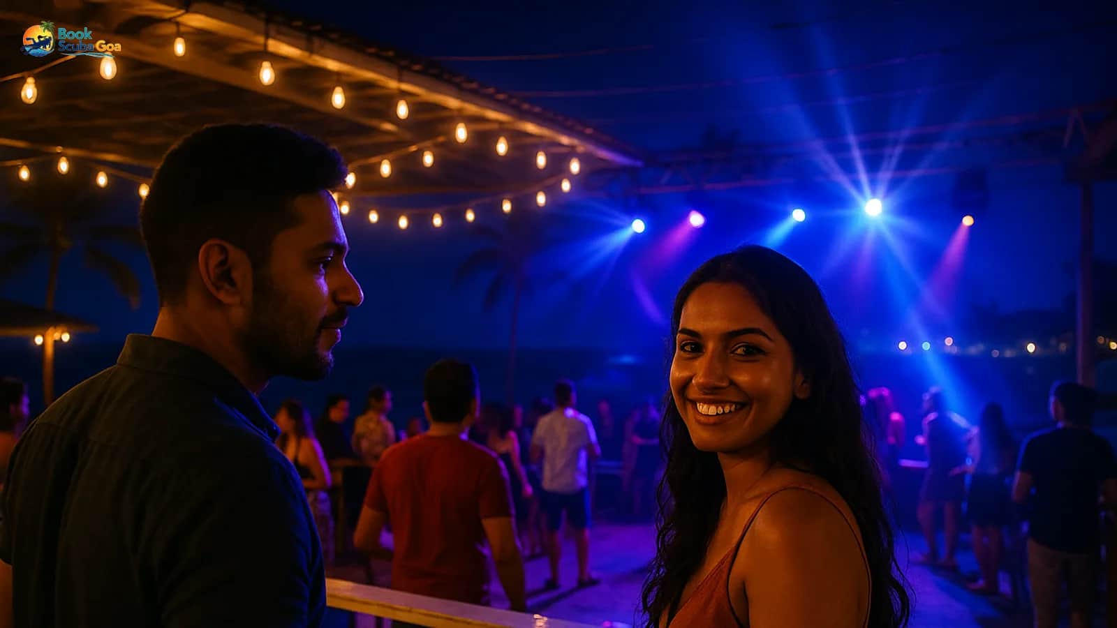 Stylish beach-club terrace at night overlooking the Arabian Sea with warm string lights