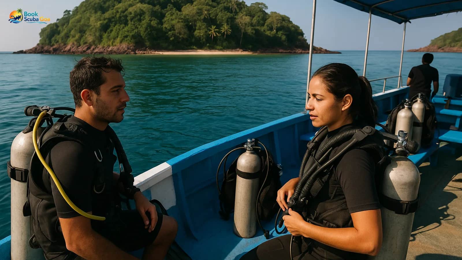 Small diving boat approaching a tropical island with divers preparing equipment on deck